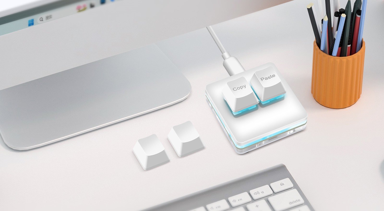 Two-Key Macro Pad beside a monitor in a bright workspace
